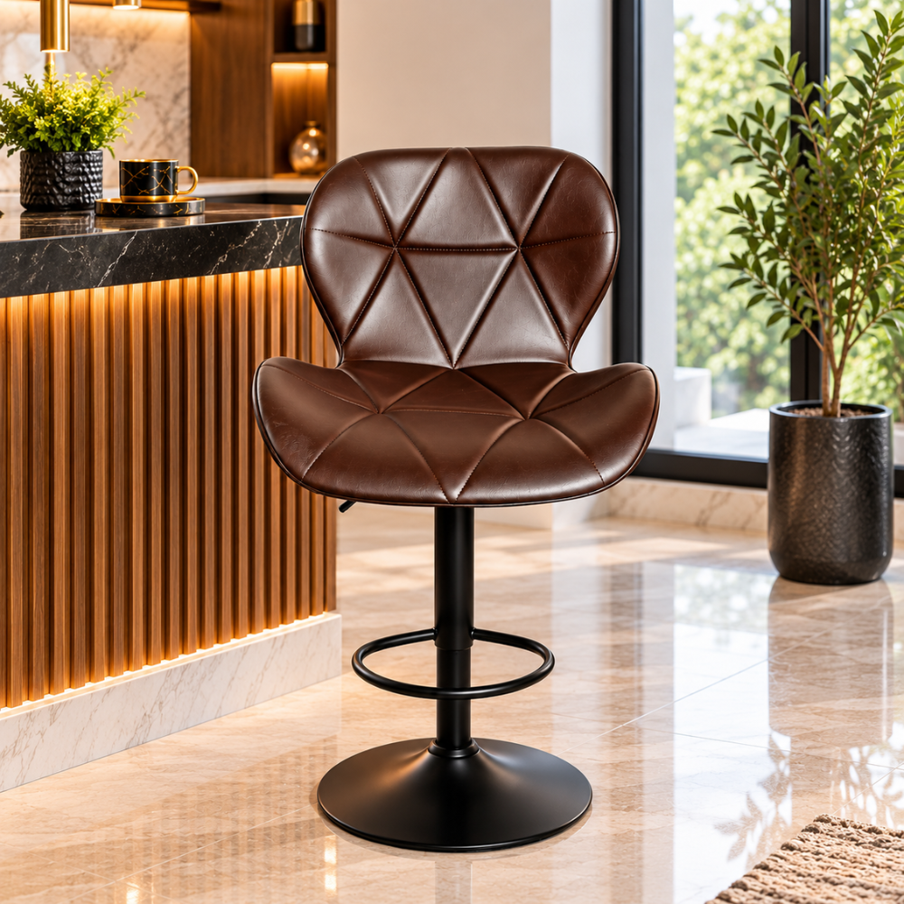 A brown leather swivel bar stool with a diamond-quilted backrest and seat, mounted on a black metal pedestal base with a footrest ring, set in a modern kitchen interior.